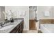 Modern bathroom with double vanity, soaking tub, and walk-in shower at 8142 Kalson St, Huntersville, NC 28078