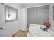 Bathroom with corner bathtub, stone wall, and linen cabinet at 1115 Marys Grove Church Rd # 1, Kings Mountain, NC 28086