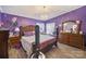 Purple bedroom with a large bed and dresser at 1115 Marys Grove Church Rd # 1, Kings Mountain, NC 28086