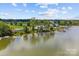 Scenic aerial view of lakeside homes with private docks and lush greenery at 112 Tallow Ct, Mooresville, NC 28117