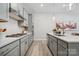 Modern kitchen with gray cabinets, white quartz countertops, and gas cooktop at 1184 Lost Cove Rd, Indian Land, SC 29707