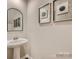 Small powder room with pedestal sink and framed art at 127 Watuga Pl, Statesville, NC 28625