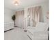 Peaceful Bedroom with a comfortable armchair and crib at 15107 Cimarron Hills Ln, Charlotte, NC 28278