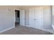 Bedroom with double doors and carpet flooring at 169 Wylie Trl, Statesville, NC 28677