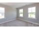 Bright bedroom with three windows and neutral walls at 169 Wylie Trl, Statesville, NC 28677