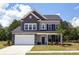 Two-story home with gray siding, stone accents, and a two-car garage at 169 Wylie Trl, Statesville, NC 28677