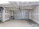 Empty garage with overhead door and concrete floor at 169 Wylie Trl, Statesville, NC 28677