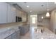 Modern kitchen with gray cabinets, granite countertops, and stainless steel appliances at 169 Wylie Trl, Statesville, NC 28677