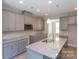 Modern kitchen with gray cabinets, granite countertops, and stainless steel appliances at 169 Wylie Trl, Statesville, NC 28677