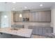 Modern kitchen with gray cabinets, granite countertops, and stainless steel appliances at 169 Wylie Trl, Statesville, NC 28677
