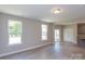 Open living room with hardwood floors and access to kitchen and patio at 169 Wylie Trl, Statesville, NC 28677