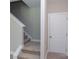Modern staircase with neutral carpeting and a white door at 169 Wylie Trl, Statesville, NC 28677