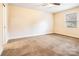 Spacious bedroom with carpet, window, and closet at 202 Belton Ave, Mount Holly, NC 28120