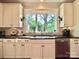 Bright kitchen with white cabinets, granite counters, and large windows at 2129 E 8Th St, Charlotte, NC 28204