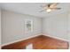 Bedroom with hardwood floors, ceiling fan, and large window at 2505 Ashford Dr, Newton, NC 28658