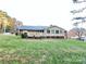 Home's back features a deck and sunroom overlooking a grassy yard at 2601 Independence Way, Gastonia, NC 28056