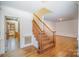 Wooden staircase with white wainscoting and hardwood floors in the foyer at 327 Wednesbury Blvd, Charlotte, NC 28262