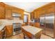 Kitchen with wood cabinets, stainless steel appliances, and a butcher block island at 327 Wednesbury Blvd, Charlotte, NC 28262