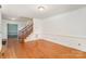 Empty living room with hardwood floors, white walls, and chair rail at 327 Wednesbury Blvd, Charlotte, NC 28262