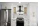 Updated kitchen with stainless steel appliances and white cabinets at 3919 Sunnycrest Ln, Charlotte, NC 28217