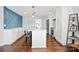 Stylish kitchen boasts white cabinets, a statement blue wall, and an island at 3919 Sunnycrest Ln, Charlotte, NC 28217