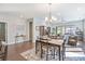 Bright dining area with a table and chairs, hardwood floors, and access to the living room at 4779 Looking Glass Trl, Denver, NC 28037