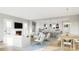 Open living space with white slipcovered furniture, fireplace, and island kitchen at 4959 Marina Dr # 202, Sherrills Ford, NC 28673