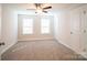 Spacious bedroom with ceiling fan, carpet flooring, and window blinds at 630 Smith St # B, Mooresville, NC 28115