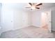 Well-lit bedroom featuring carpet floors and multiple closets at 630 Smith St # B, Mooresville, NC 28115