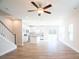 Open living space with kitchen, stairs, and ceiling fan at 630 Smith St # B, Mooresville, NC 28115