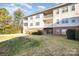 Brick and siding building with multiple levels, balconies, and green space at 9315 Meadow Vista Rd, Charlotte, NC 28213