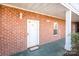 Brick building exterior with a welcoming entrance and a white door at 9315 Meadow Vista Rd, Charlotte, NC 28213