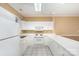 White kitchen cabinets, appliances, and tile floor at 9315 Meadow Vista Rd, Charlotte, NC 28213