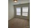 Bright bedroom with carpet flooring and two windows at 9956 Kings Parade Blvd, Charlotte, NC 28273