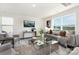 Living room with gray sofa, coffee table, and large windows at 1015 20Th Ave Se Loop, Hickory, NC 28602