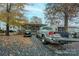 Tan single-story home with covered porch and golf cart, surrounded by autumn leaves at 108 Fathom Trl # 178, Mount Gilead, NC 27306