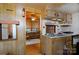 Small kitchen with sink, stove, and access to living room at 108 Fathom Trl # 178, Mount Gilead, NC 27306