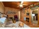Living room featuring wood walls, a couch, and access to the kitchen at 108 Fathom Trl # 178, Mount Gilead, NC 27306