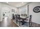 Dining room with a wood table and six chairs, adjacent to kitchen at 12936 Canton Side Ave, Charlotte, NC 28273