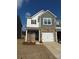 Two-story brick home with gray siding, two-car garage, and landscaping at 12936 Canton Side Ave, Charlotte, NC 28273