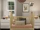 Charming Bedroom featuring a crib, soft pillows, and nature-themed art at 15229 Windy Plains Rd, Charlotte, NC 28262