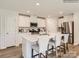 Modern kitchen with white cabinets, stainless steel appliances, and an island at 15237 Windy Plains Rd, Charlotte, NC 28262