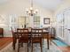 Dining room with hardwood floors, chandelier, and access to backyard at 2713 New Hamlin Way, Charlotte, NC 28210