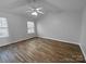 Primary bedroom with vaulted ceiling, wood-look floors, and a window at 4438 Cochran Farm Ln, Charlotte, NC 28269
