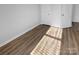 Light and airy bedroom with wood-look floors and double doors at 4438 Cochran Farm Ln, Charlotte, NC 28269