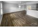 Open living room featuring hardwood floors and a kitchen island at 4438 Cochran Farm Ln, Charlotte, NC 28269