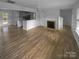 Living room with hardwood floors, fireplace and kitchen views at 4438 Cochran Farm Ln, Charlotte, NC 28269