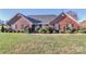 Brick ranch-style home with a well-maintained lawn and landscaping at 523 Fort Dobbs Rd, Statesville, NC 28625