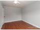 Bedroom with hardwood floors, ceiling fan, and white door at 621 Spruce St, Mooresville, NC 28115