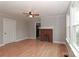 Bright living room with hardwood floors, a brick fireplace, and a ceiling fan at 621 Spruce St, Mooresville, NC 28115